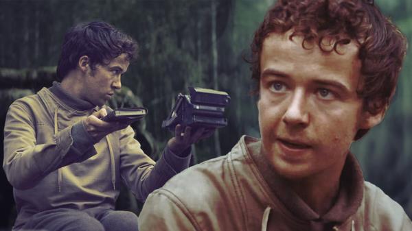 An edited image of Alex Lawther as Karis Nemik looking at technological devices in Andor